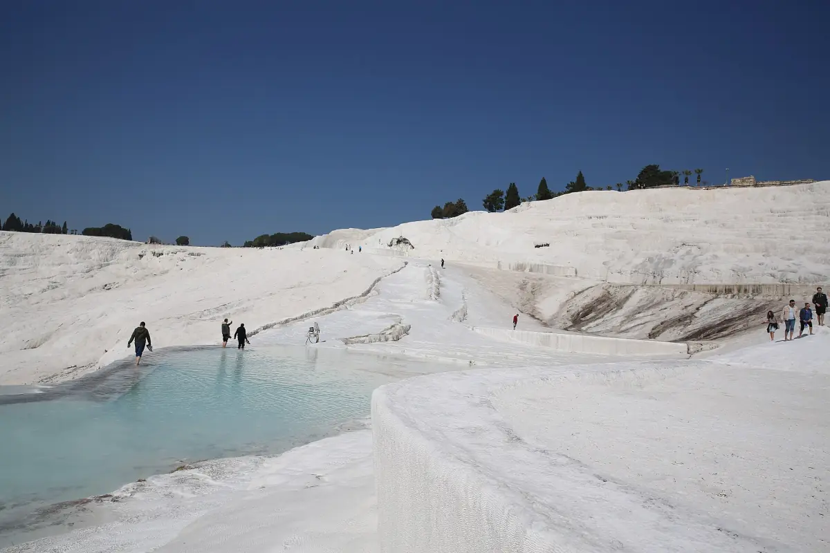 Visitors walking on the travertines